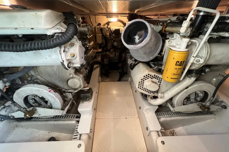 Slide: The Image of Engine room of a 2004 Henriques 35 Sportfisherman, showcasing dual engines and components. - 83