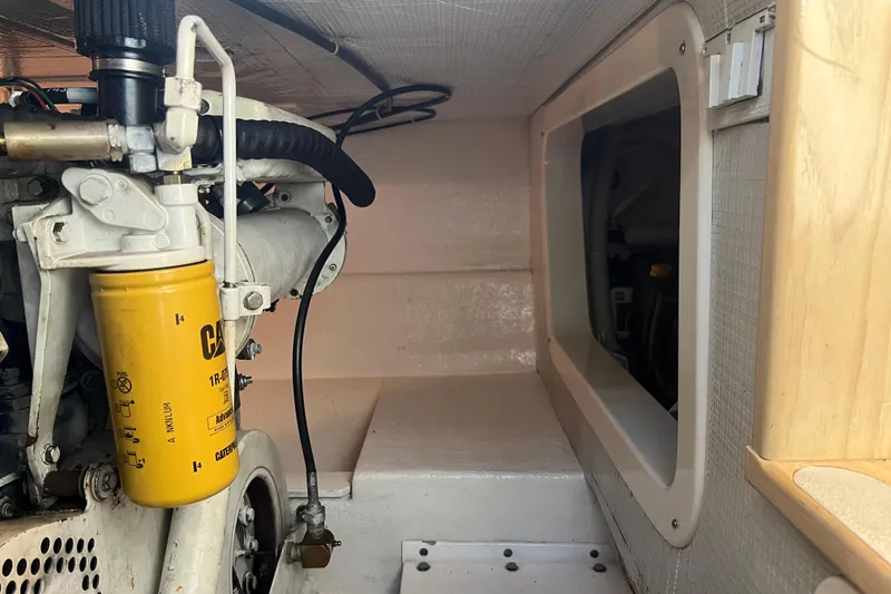 Slide: The Image of Engine compartment of a 2004 Henriques 35 Sportfisherman, featuring a CAT filter. - 85