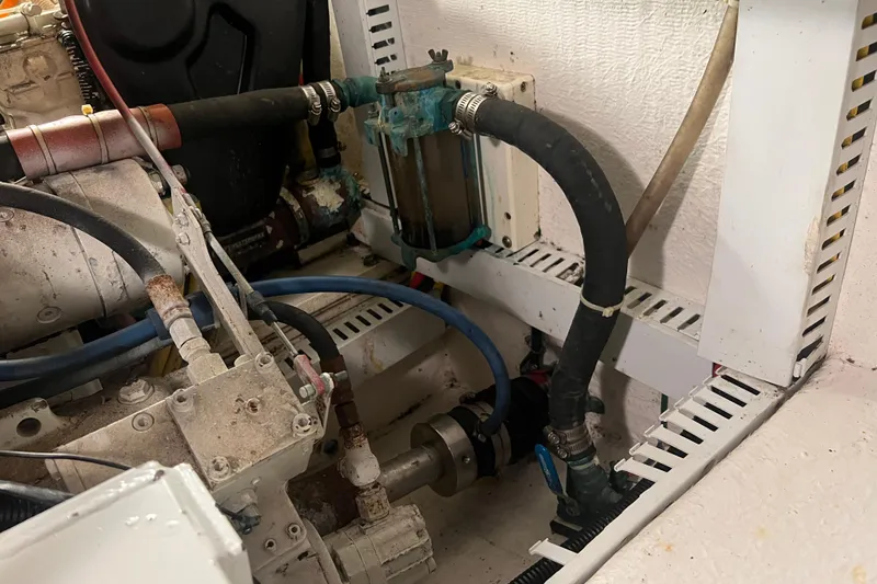 Slide: The Image of Engine compartment of a 2004 Henriques 35 Sportfisherman with visible hoses and components. - 91