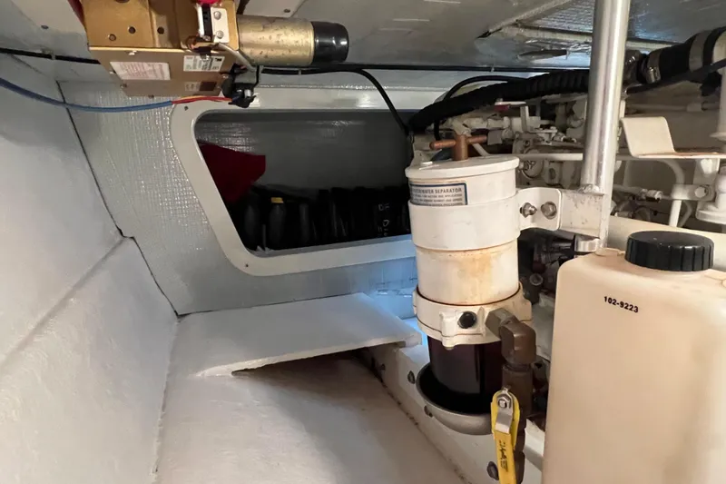 Slide: The Image of Engine room of 2004 Henriques 35 Sportfisherman, featuring fuel filter and separator system. - 92