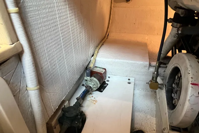 Slide: The Image of Engine room of 2004 Henriques 35 Sportfisherman, showing mechanical components and piping. - 94