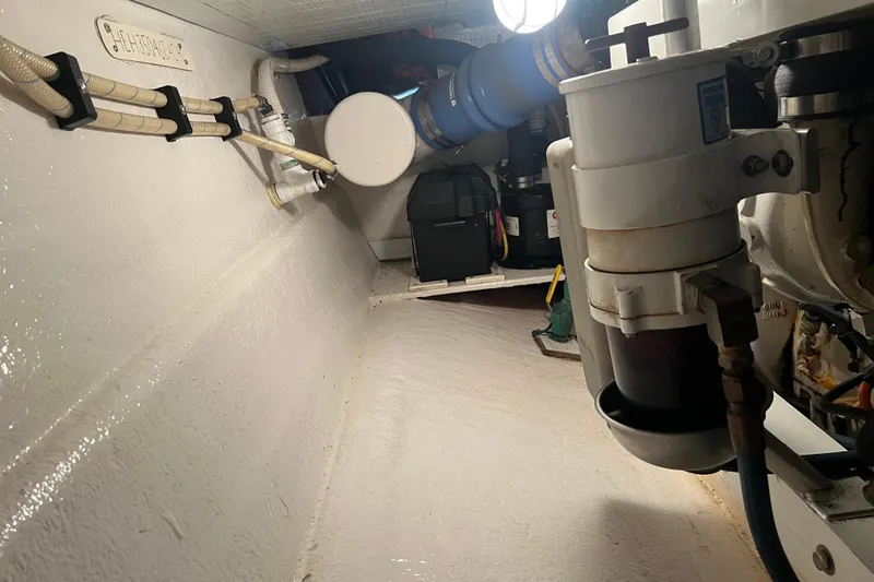 Slide: The Image of Engine room of a 2004 Henriques 35 Sportfisherman, showcasing mechanical components and wiring. - 95