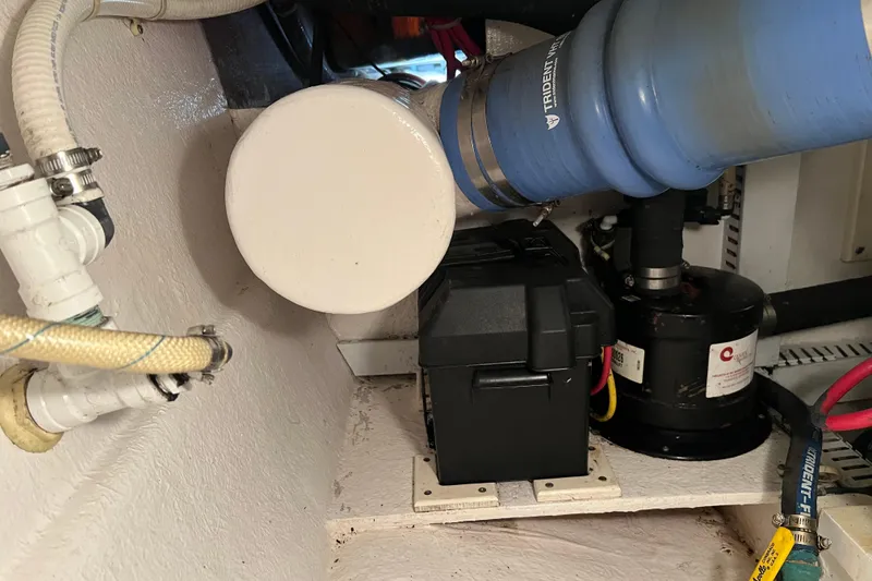 Slide: The Image of Engine compartment of a 2004 Henriques 35 Sportfisherman with visible hoses and components. - 96