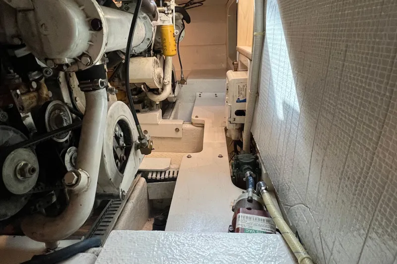 Slide: The Image of Engine room of a 2004 Henriques 35 Sportfisherman boat, showcasing mechanical components. - 99
