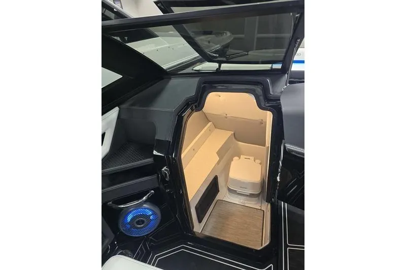 Slide: The Image of 2026 Cobalt R8 Surf boat interior with storage compartment and modern speaker system. - 10