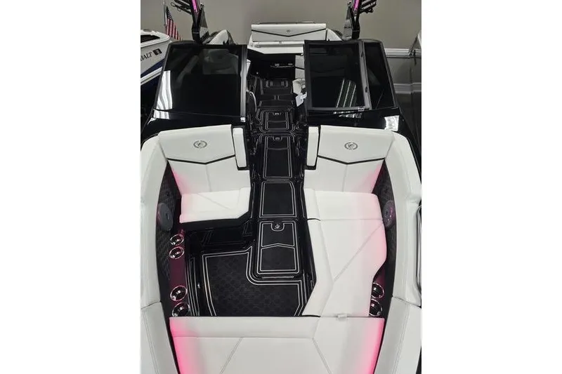 Slide: The Image of 2026 Cobalt R8 Surf boat interior with sleek black and white seating and ambient lighting. - 7