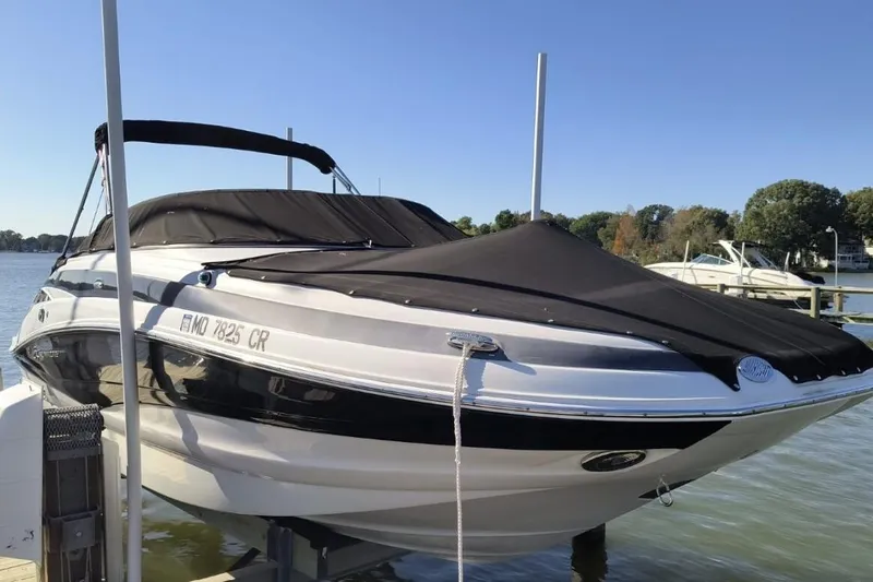 The Image of 2014 Crownline Eclipse E2 XS boat docked with black cover on a sunny day. - 1