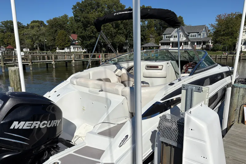 Slide: The Image of 2014 Crownline Eclipse E2 XS boat docked, featuring Mercury engine, sunny day, waterfront homes. - 12