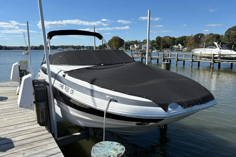Slide: The Image of 2014 Crownline Eclipse E2 XS boat docked with cover on a sunny day. - 3