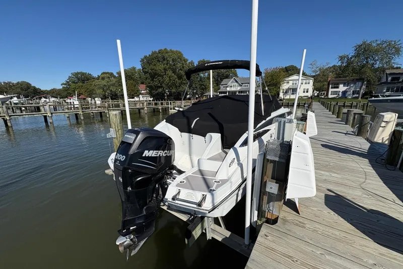 Slide: The Image of 2014 Crownline Eclipse E2 XS boat docked with Mercury engine, covered and ready for use. - 5