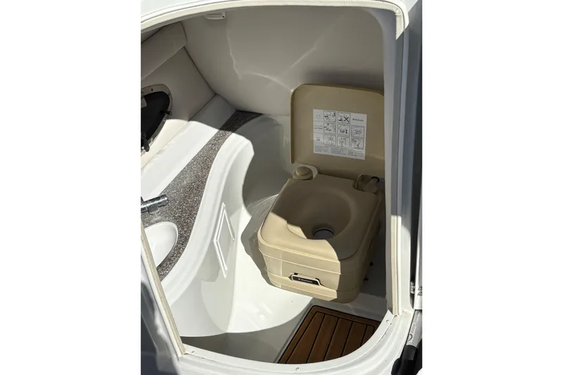 Slide: The Image of 2014 Crownline Eclipse E2 XS boat interior with compact toilet and sink. - 6