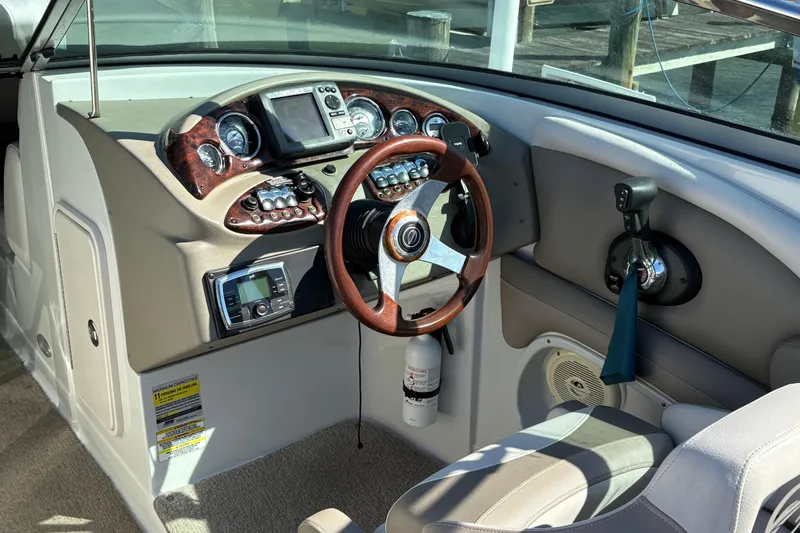 Slide: The Image of 2014 Crownline Eclipse E2 XS boat dashboard with steering wheel and controls. - 7