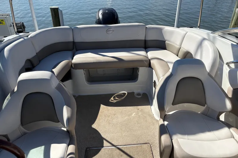 Slide: The Image of 2014 Crownline Eclipse E2 XS boat interior with gray seating and water view. - 8