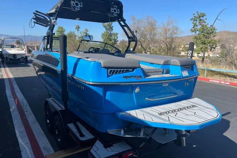 Slide: The Image of 2022 Moomba Kaiyen boat interior with gray seating and blue accents. - 11