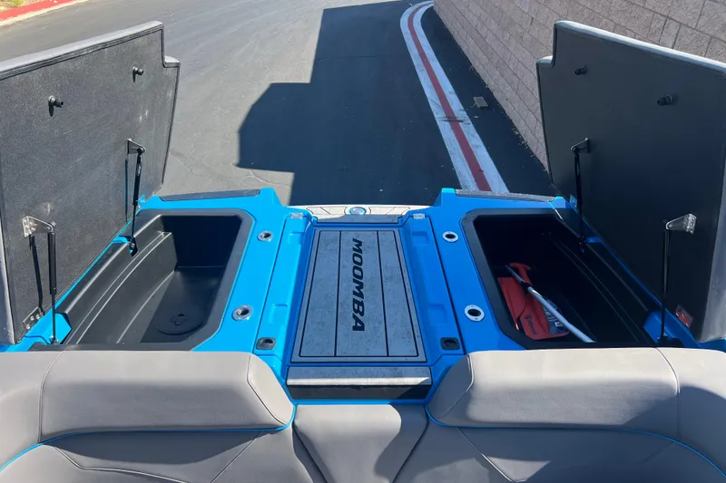 Slide: The Image of 2022 Moomba Kaiyen boat storage compartment with open lid, showcasing interior space. - 28