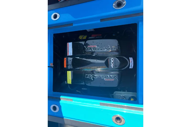 Slide: The Image of 2022 Moomba Kaiyen boat seat storage compartment open, showcasing interior space. - 29