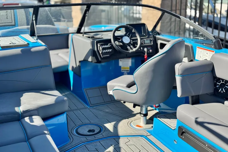 Slide: The Image of 2022 Moomba Kaiyen boat on trailer, blue hull, parked outdoors. - 3