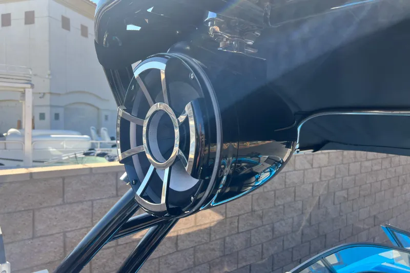 Slide: The Image of 2022 Moomba Kaiyen interior with speakers and cup holders, featuring sleek gray upholstery. - 39