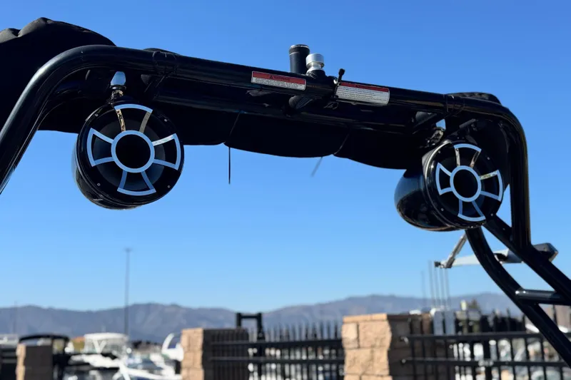 Slide: The Image of 2022 Moomba Kaiyen boat in vibrant blue on a trailer, scenic background. - 4