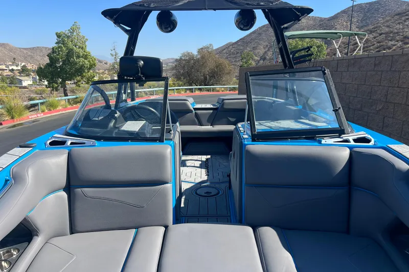 Slide: The Image of 2022 Moomba Kaiyen boat with bold logo on blue and black hull. - 9