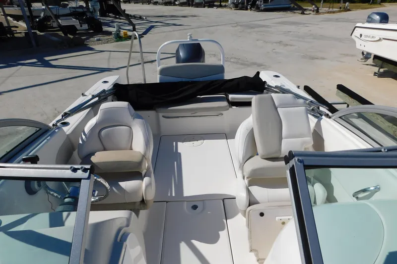 Slide: The Image of 2014 Robalo R207 Dual Console boat interior with seating and steering wheel. - 16