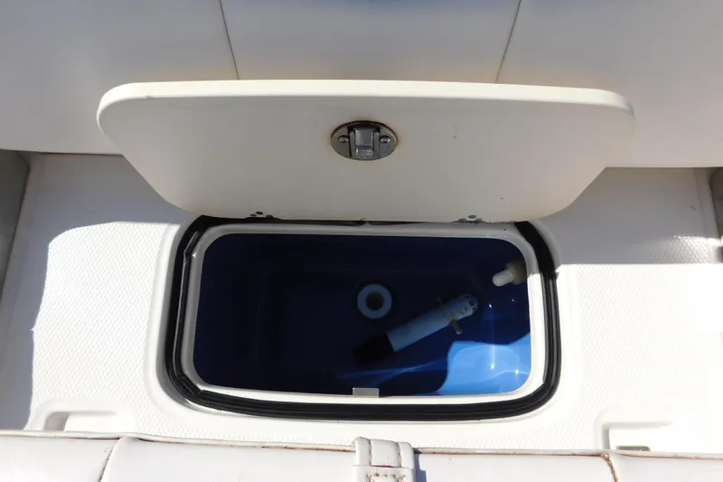 Slide: The Image of 2014 Robalo R207 Dual Console livewell with open lid, showcasing interior features. - 19