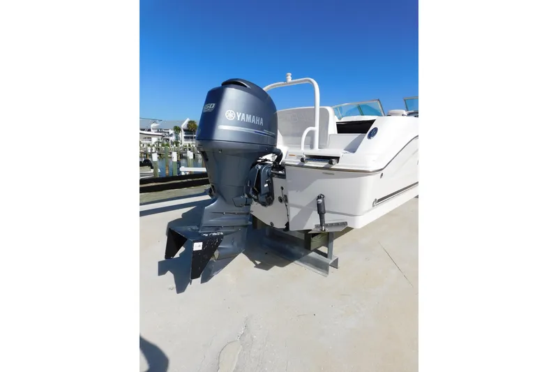 Slide: The Image of 2014 Robalo R207 Dual Console boat with Yamaha outboard motor, docked under clear blue sky. - 6