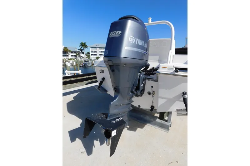 Slide: The Image of 2014 Robalo R207 Dual Console with Yamaha outboard motor, docked in a sunny marina. - 7