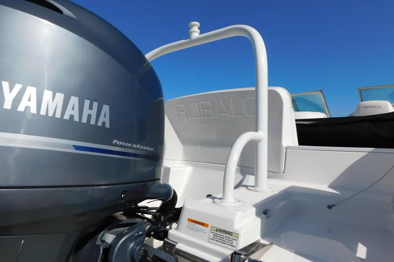 Slide: The Image of 2014 Robalo R207 Dual Console with Yamaha four-stroke engine, clear blue sky background. - 9