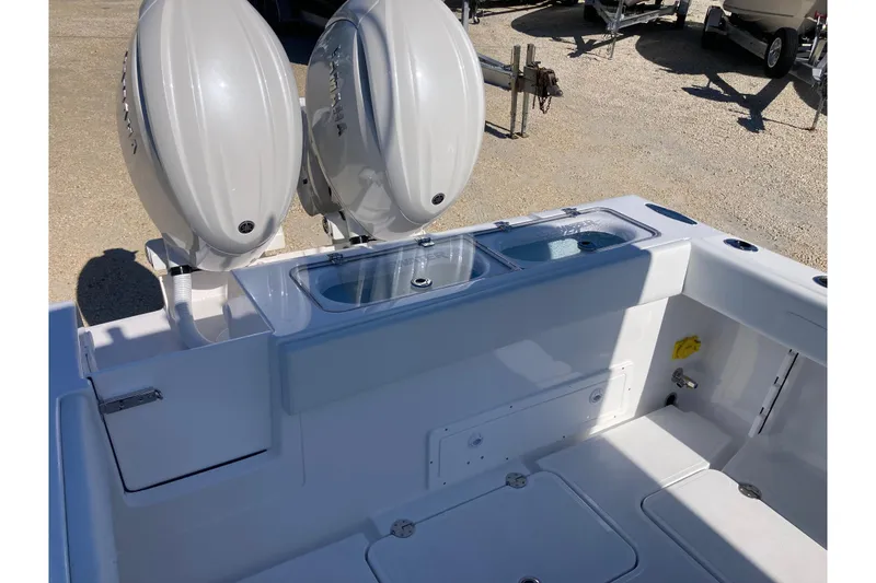 Slide: The Image of 2026 Bluewater 25 T boat with dual outboard engines and spacious deck layout. - 10