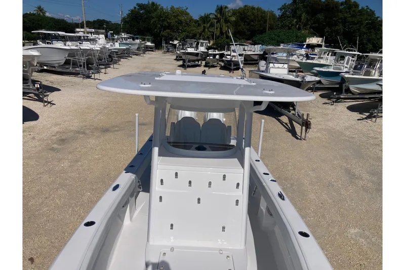 Slide: The Image of 2026 Bluewater 25 T boat in a marina, surrounded by various other boats. - 8