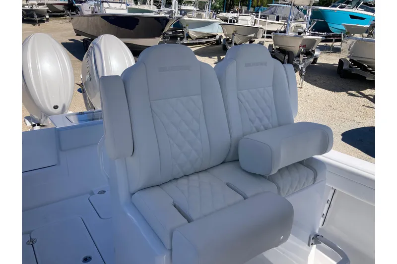 Slide: The Image of Luxurious seating on 2026 Bluewater 25 T boat, featuring quilted white upholstery. - 9