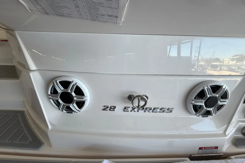 Slide: The Image of 2026 Regal 28 Express boat rear view with speakers and model name. - 11