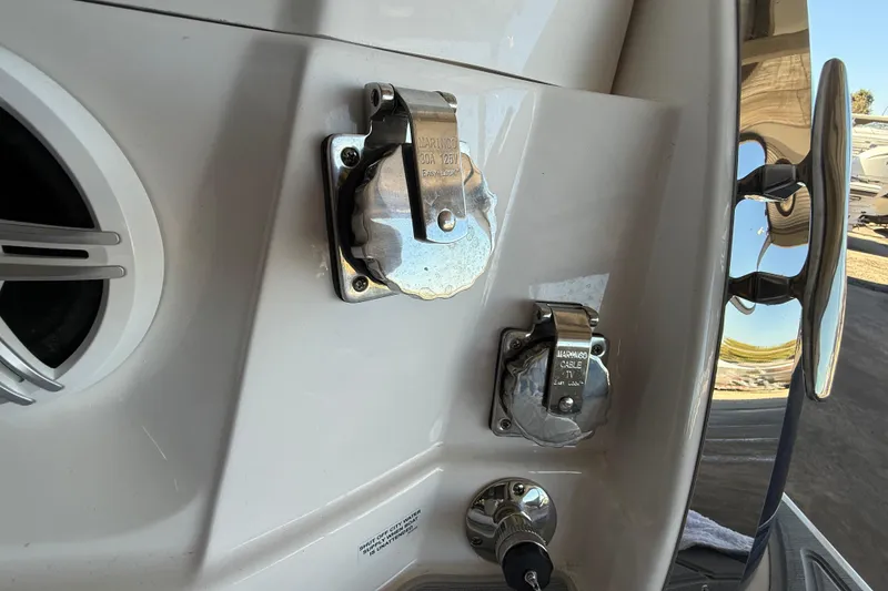 Slide: The Image of 2026 Regal 28 Express boat power connections and cable ports close-up. - 12