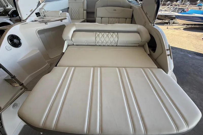 Slide: The Image of 2026 Regal 28 Express boat interior with convertible seating and luxurious upholstery. - 15