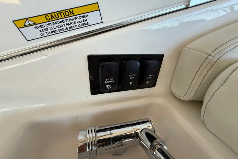 Slide: The Image of Control panel on 2026 Regal 28 Express boat with caution label and switches. - 18