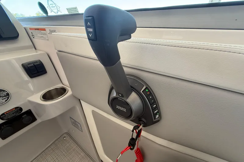 Slide: The Image of Throttle control of 2026 Regal 28 Express boat, featuring trim and cruise functions. - 25