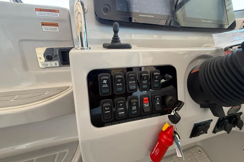 Slide: The Image of Control panel of 2026 Regal 28 Express boat with switches and ignition keys. - 27