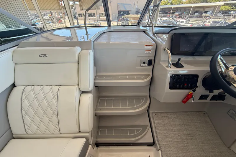 Slide: The Image of Interior view of 2026 Regal 28 Express boat cockpit with seating and control panel. - 32
