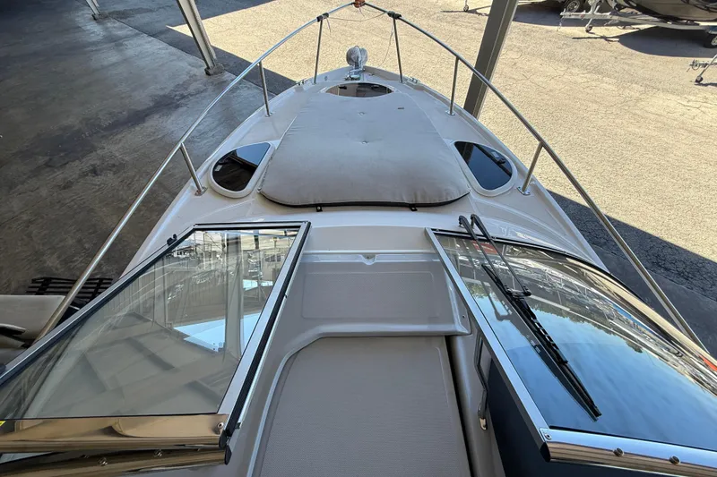 Slide: The Image of 2026 Regal 28 Express boat deck with open windshield, docked in a marina. - 34