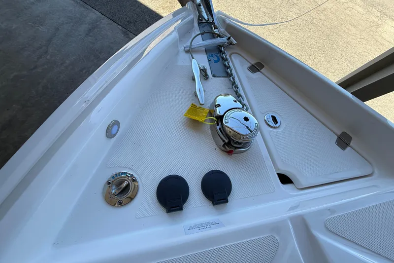 Slide: The Image of 2026 Regal 28 Express boat anchor system with chain and winch on deck. - 35