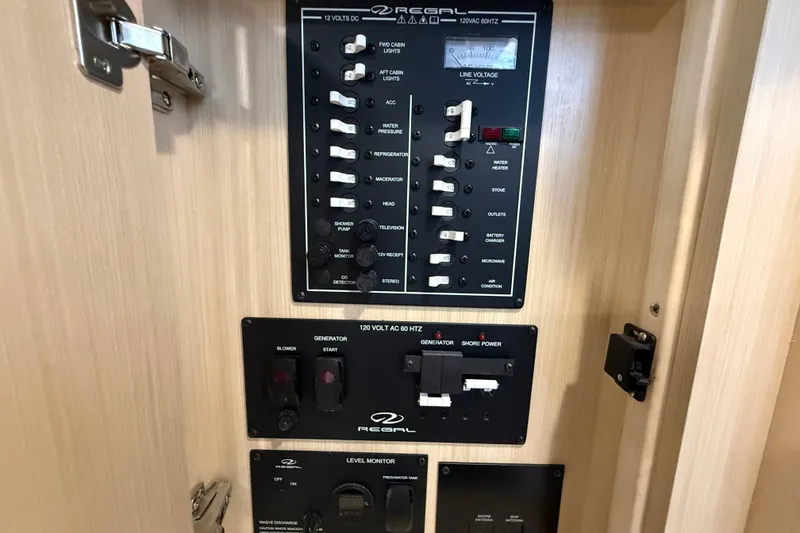 Slide: The Image of Electrical control panel of 2026 Regal 28 Express boat, featuring switches and gauges. - 42