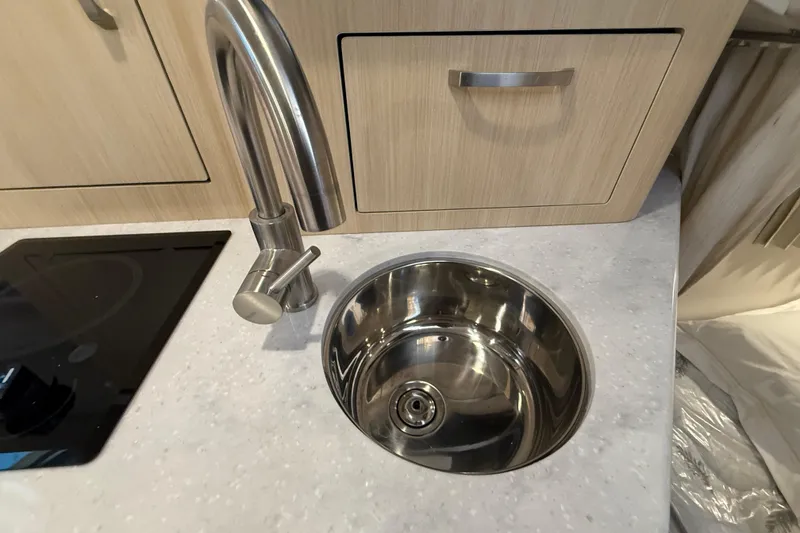 Slide: The Image of Modern kitchen sink and faucet in 2026 Regal 28 Express boat interior. - 47