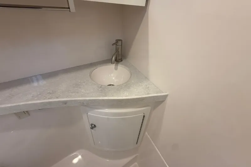 Slide: The Image of 2026 Regal 28 Express boat bathroom with modern sink and faucet. - 53