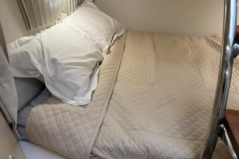 Slide: The Image of Cozy cabin bed in 2026 Regal 28 Express boat with quilted bedding. - 58