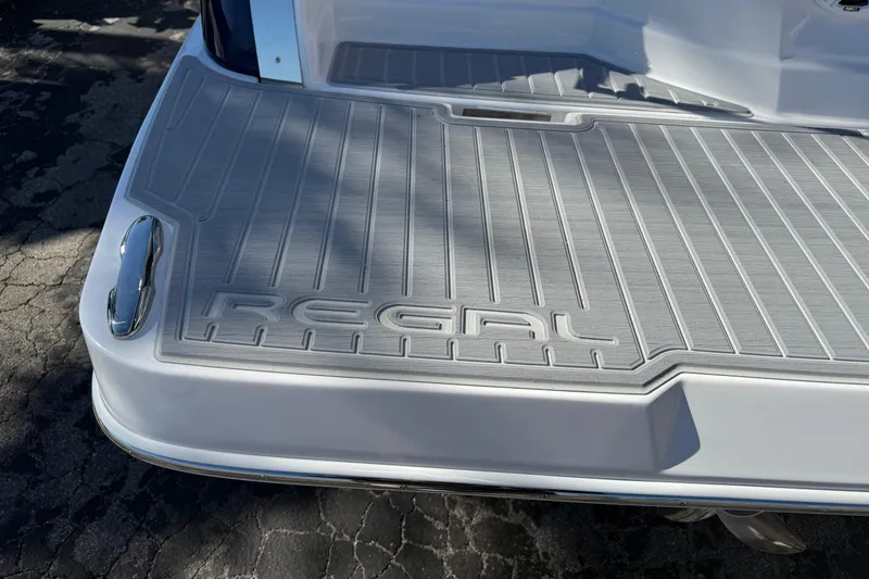Slide: The Image of 2026 Regal 28 Express boat swim platform with embossed logo and sleek design. - 6