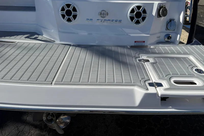 Slide: The Image of 2026 Regal 28 Express boat stern with speakers and swim platform. - 7
