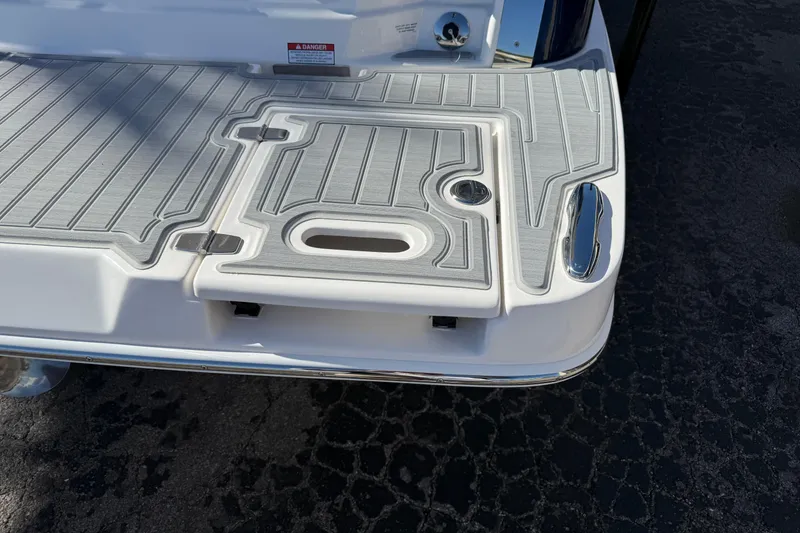 Slide: The Image of 2026 Regal 28 Express boat swim platform with textured surface and chrome details. - 8
