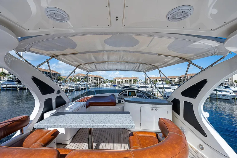 Slide: The Image of Luxurious 2009 Aicon 64 yacht interior with leather seating and marina view. - 6