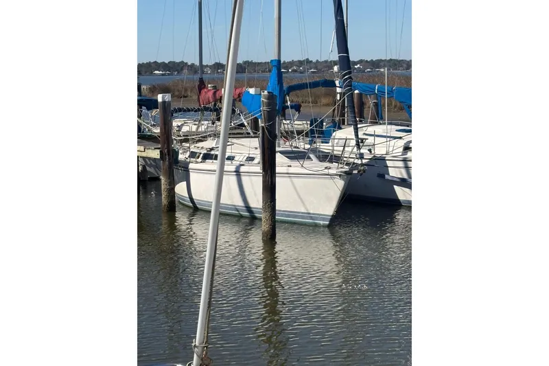 The Image of 1989 Catalina 30 sailboat docked in harbor. - 0